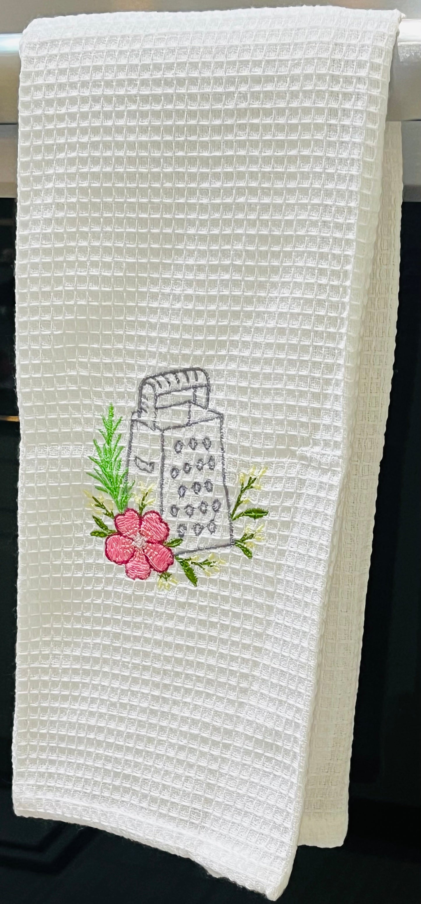 Embroidered cheese grater and floral kitchen towel