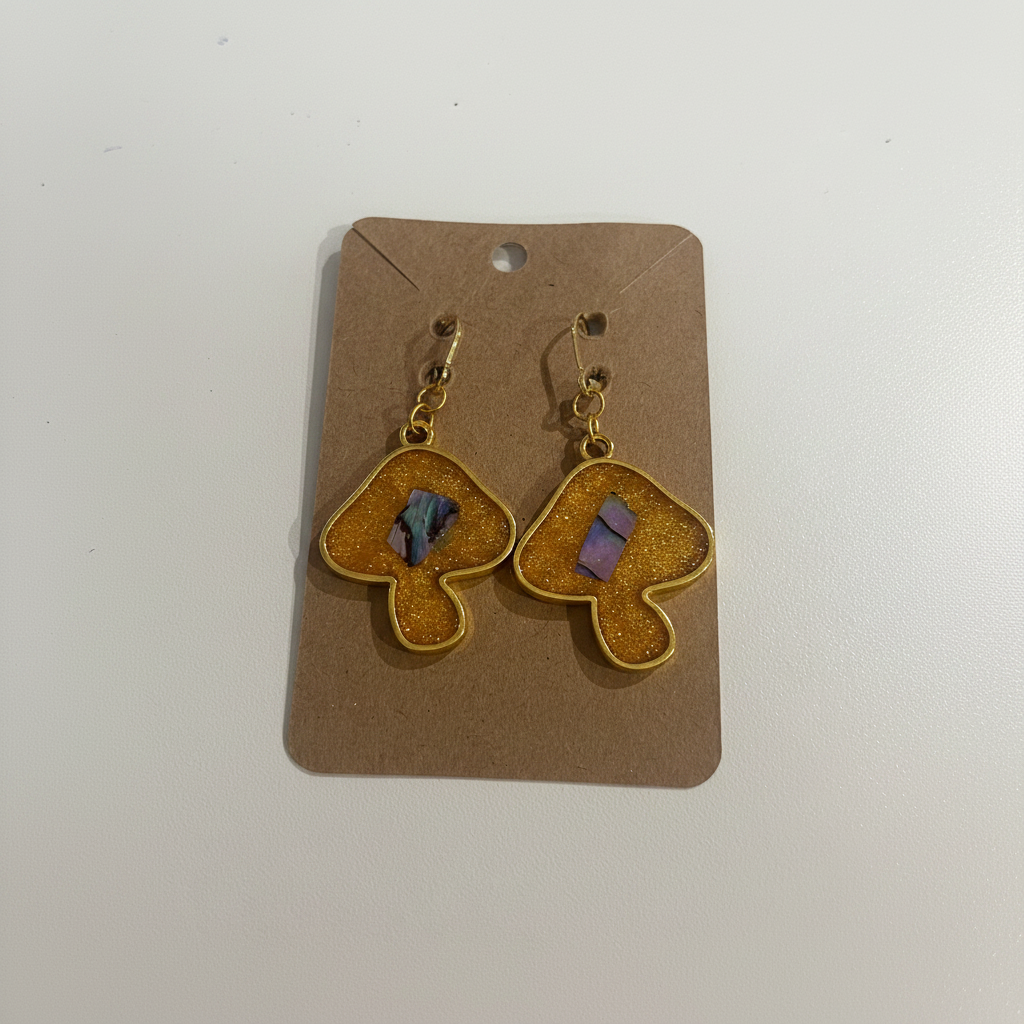 Gold mushroom earrings bright product shot on card