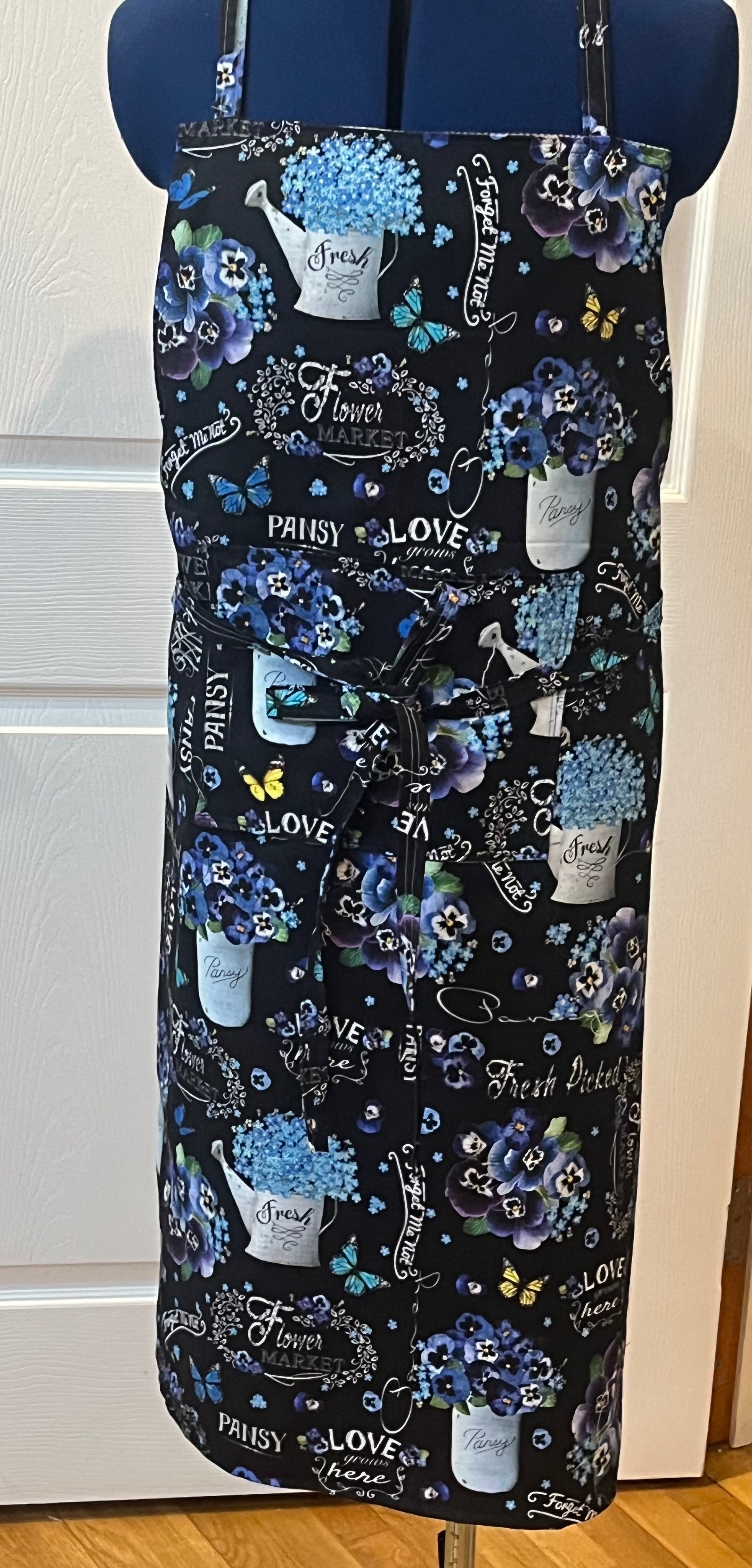 Flower market pansy bib apron - front view showing black floral print