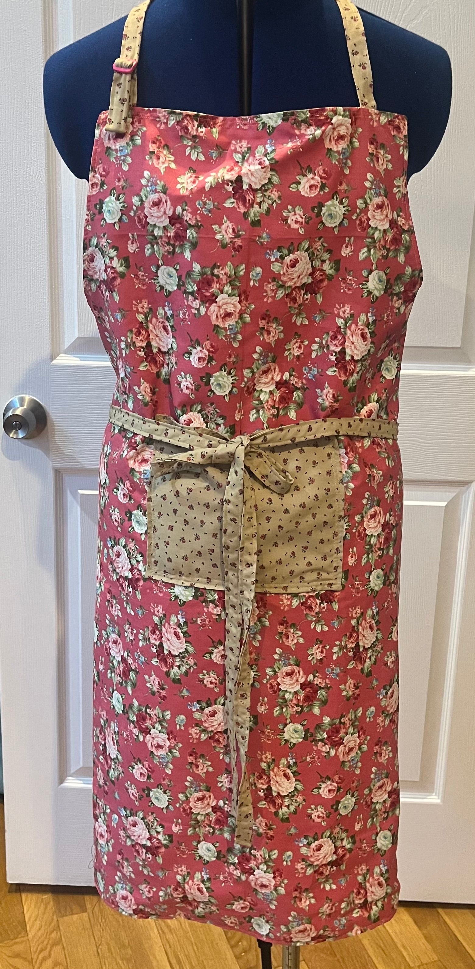 Rose garden bib apron - front view on dress form