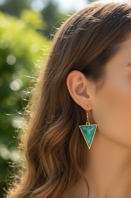Teal triangle resin earrings on model