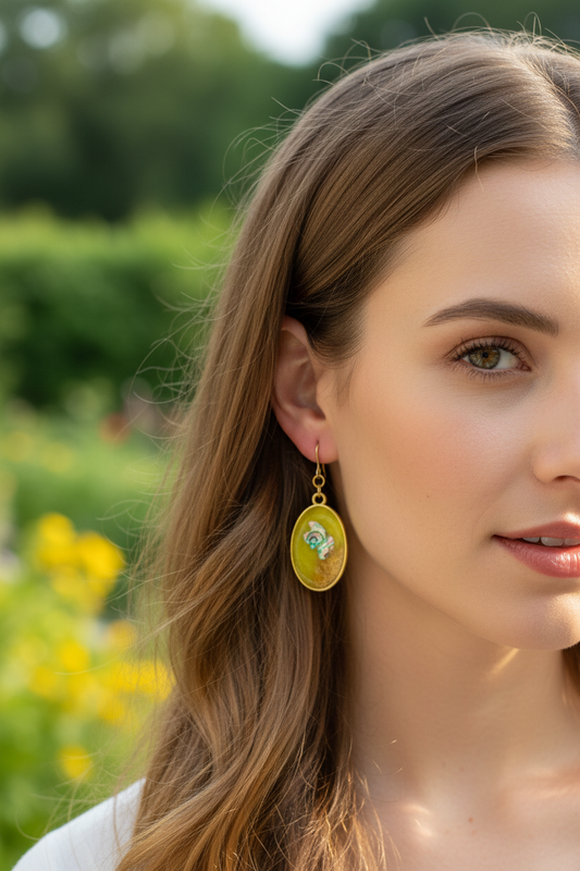 Yellow green oval abalone resin earrings on model